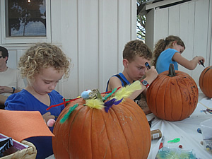 Children carving their pumpkins at the Pumpkin Patch. Children carving their pumpkins at the Pumpkin Patch.